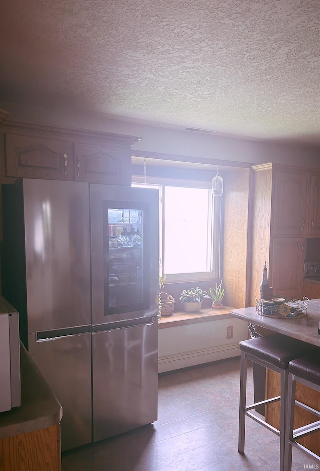 kitchen featuring smart refrigerator and a textured ceiling