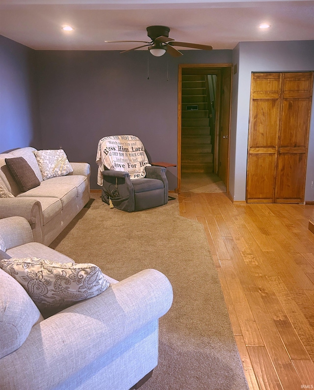 living room featuring stairs, a ceiling fan, recessed lighting, and light wood-type flooring