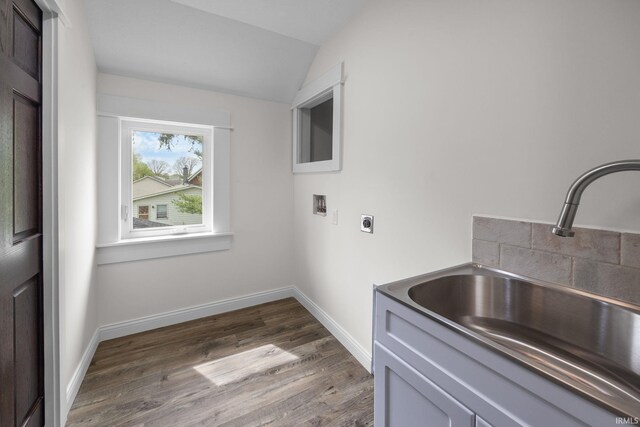 clothes washing area with cabinet space, washer hookup, a sink, electric dryer hookup, and wood finished floors