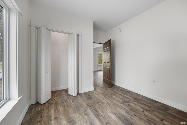 unfurnished bedroom featuring baseboards and wood finished floors