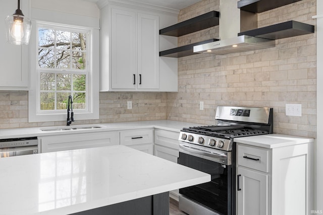 kitchen featuring stainless steel range with gas cooktop, backsplash, open shelves, and a sink
