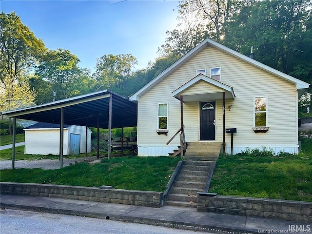 bungalow-style home with a front lawn, a shed, an outbuilding, and a carport