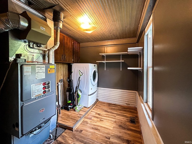 laundry area featuring wood ceiling, laundry area, visible vents, wood finished floors, and washer / dryer