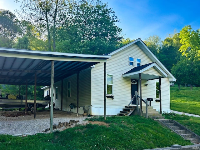 view of front of house with a front lawn and an attached carport