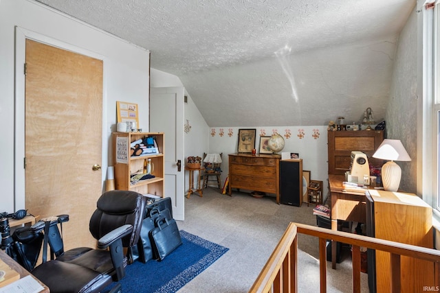 office with a textured ceiling, vaulted ceiling, and carpet