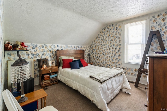bedroom with a textured ceiling, vaulted ceiling, and wallpapered walls