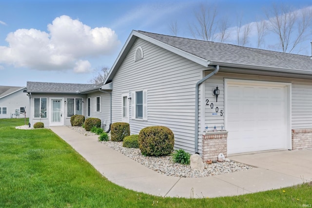 view of home's exterior with a lawn, an attached garage, concrete driveway, and a shingled roof