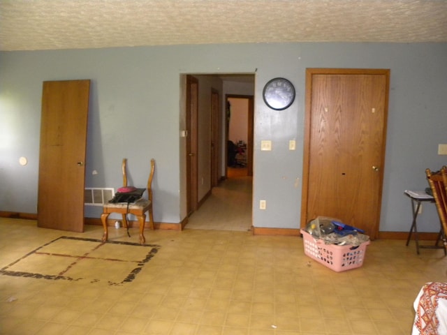 8207 Lehman Rd, Worthington, IN 47471 - interior space with baseboards, light floors, and a textured ceiling