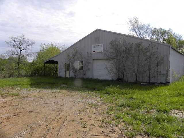 8207 Lehman Rd, Worthington, IN 47471 - view of home's exterior featuring dirt driveway, a garage, an outbuilding, and a pole building