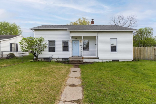 bungalow with fence, a chimney, a shingled roof, and a front yard