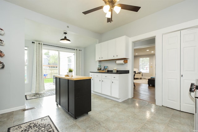 kitchen with visible vents, white cabinets, and a healthy amount of sunlight