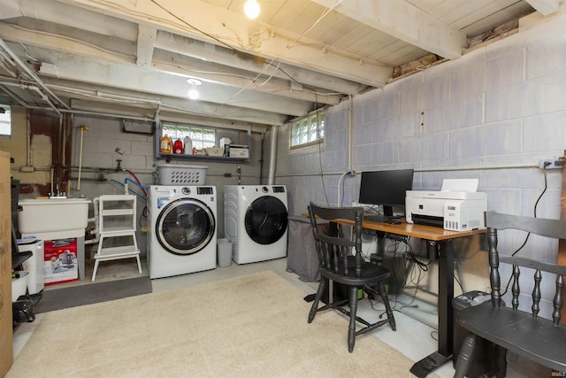 laundry room with a sink, laundry area, and washer and clothes dryer