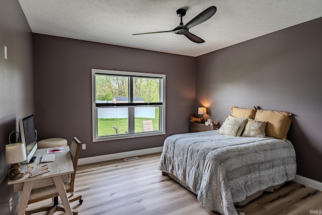 4663 Beringer Dr, Lafayette, IN 47909 - bedroom with baseboards, light wood-style flooring, ceiling fan, and a textured ceiling