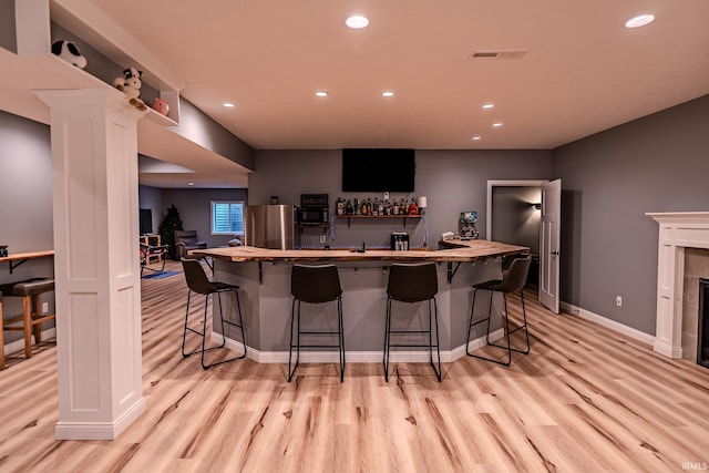 4663 Beringer Dr, Lafayette, IN 47909 - bar with light wood finished floors, freestanding refrigerator, indoor bar, visible vents, and recessed lighting