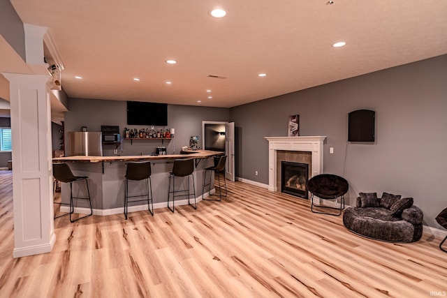4663 Beringer Dr, Lafayette, IN 47909 - bar featuring freestanding refrigerator, wet bar, light wood finished floors, and recessed lighting