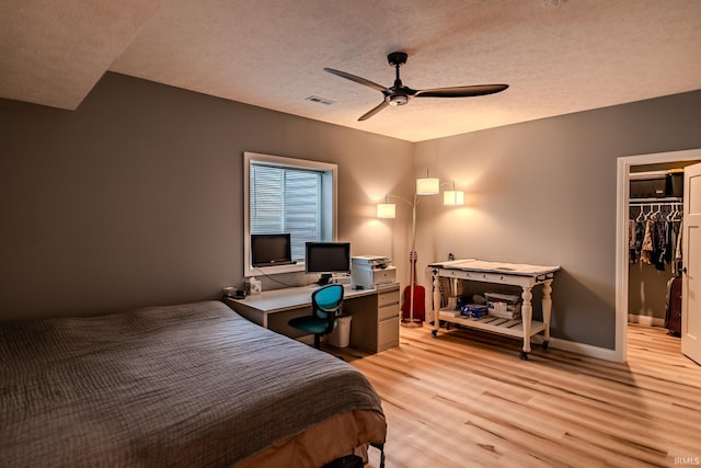 4663 Beringer Dr, Lafayette, IN 47909 - bedroom featuring a textured ceiling, light wood-type flooring, visible vents, ceiling fan, and a walk in closet