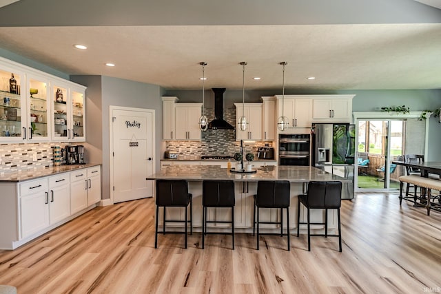 4663 Beringer Dr, Lafayette, IN 47909 - kitchen featuring recessed lighting, stainless steel double oven, decorative backsplash, wall chimney exhaust hood, and light wood-style floors