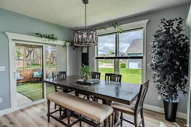 4663 Beringer Dr, Lafayette, IN 47909 - dining room with an inviting chandelier, plenty of natural light, light wood-style flooring, and baseboards