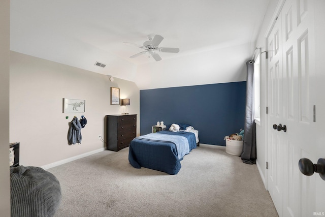carpeted bedroom with visible vents, a ceiling fan, baseboards, and lofted ceiling