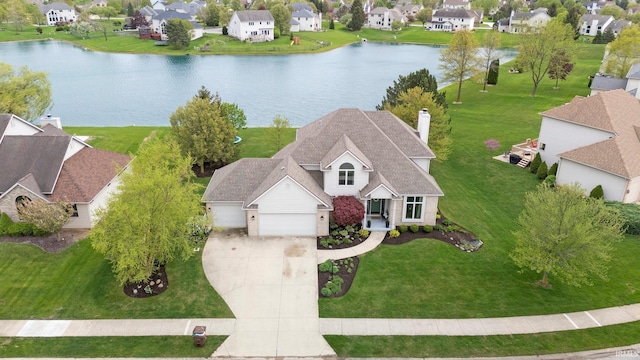 drone / aerial view with a water view and a residential view