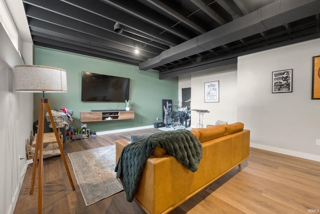 living room with baseboards and wood finished floors