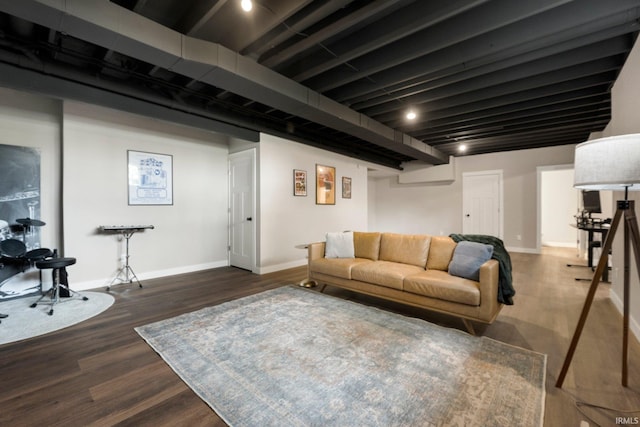 living area featuring baseboards and dark wood finished floors