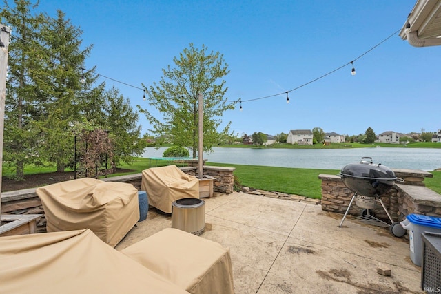 view of patio / terrace featuring area for grilling and a water view