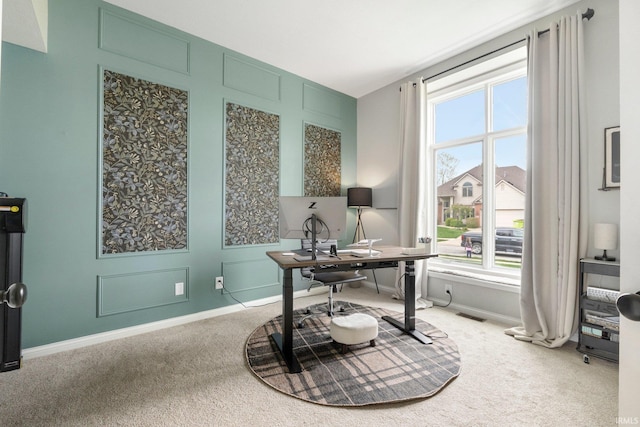 carpeted home office featuring baseboards and plenty of natural light