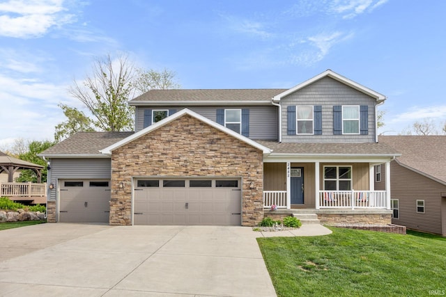 craftsman-style house with an attached garage, stone siding, covered porch, and driveway