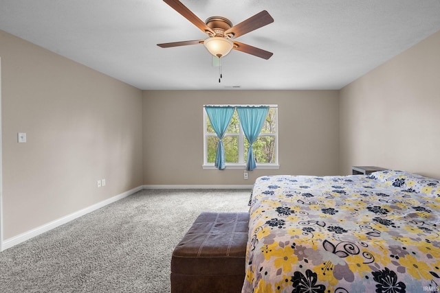 carpeted bedroom featuring baseboards and ceiling fan