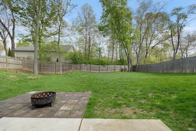 view of yard featuring a fenced backyard, an outdoor fire pit, and a patio area