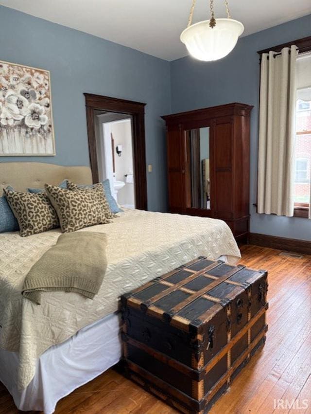 1004 SE First St, Evansville, IN 47713 - bedroom with wood-type flooring and baseboards