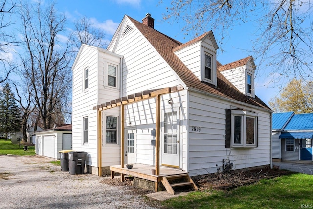 2819 Witchwood Dr, Fort Wayne, IN 46809 - rear view of property featuring roof with shingles, a chimney, and a detached garage