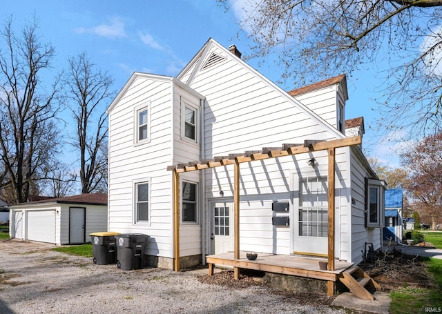 2819 Witchwood Dr, Fort Wayne, IN 46809 - rear view of property featuring a garage, an outbuilding, and a chimney