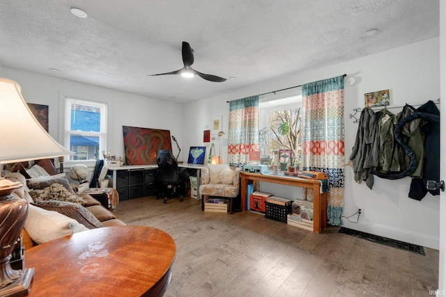 2819 Witchwood Dr, Fort Wayne, IN 46809 - living room with a ceiling fan, visible vents, a healthy amount of sunlight, and wood finished floors