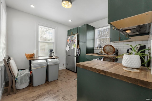 2819 Witchwood Dr, Fort Wayne, IN 46809 - kitchen with green cabinetry, wooden counters, light wood-type flooring, and a wealth of natural light