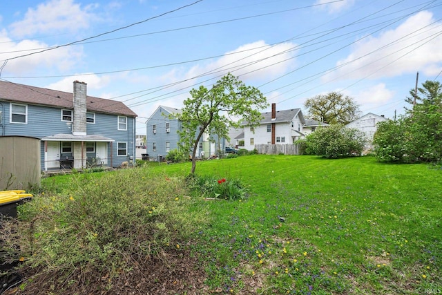 view of yard with fence and a residential view