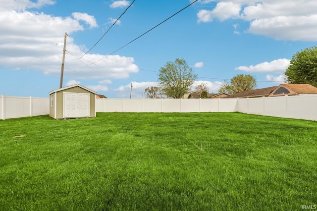 view of yard with an outdoor structure, a shed, and a fenced backyard