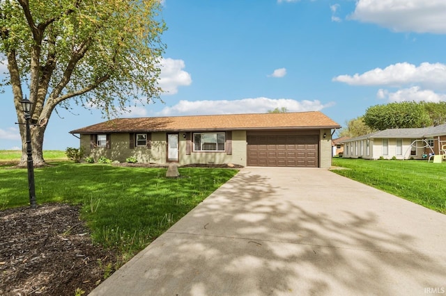 ranch-style house featuring an attached garage, a front lawn, brick siding, and concrete driveway