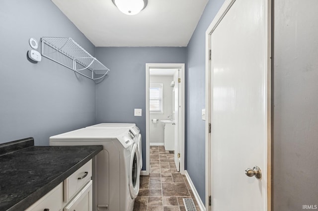 laundry room featuring washing machine and clothes dryer, laundry area, baseboards, stone finish flooring, and visible vents