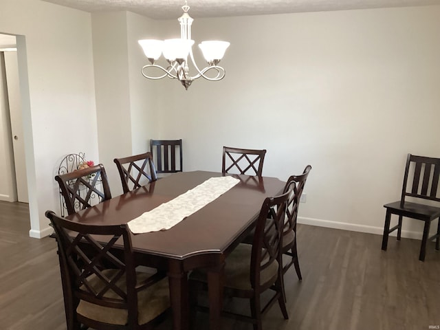 dining room with baseboards, a chandelier, and dark wood-style floors
