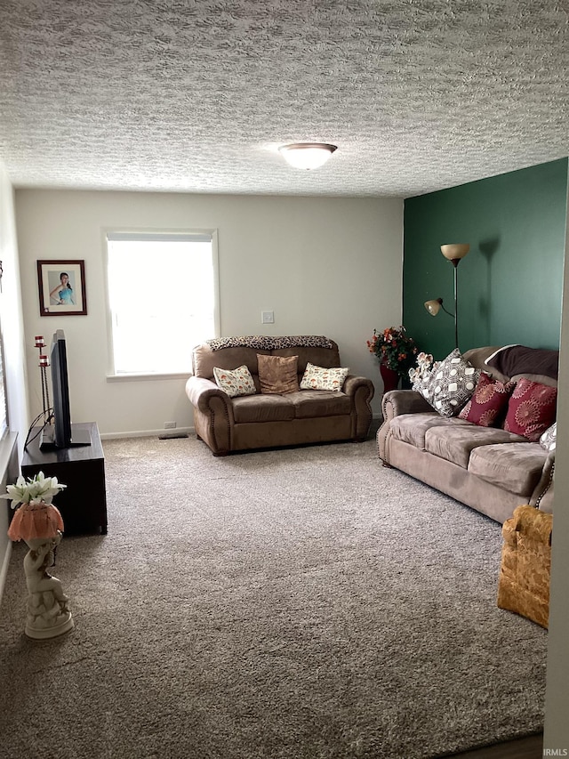 carpeted living area featuring a textured ceiling and baseboards