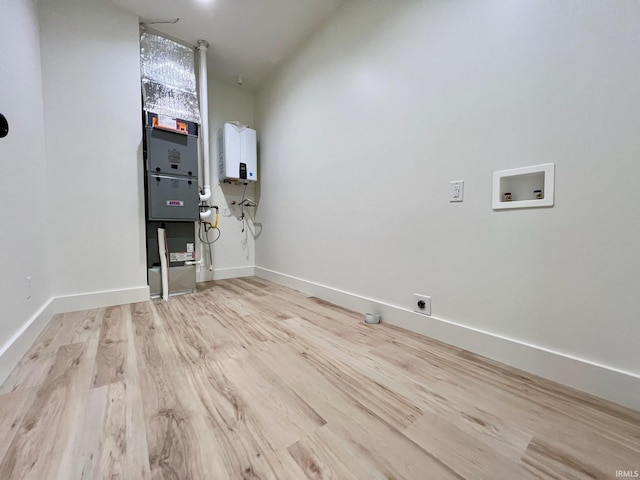 laundry room with hookup for an electric dryer, laundry area, wood finished floors, baseboards, and hookup for a washing machine