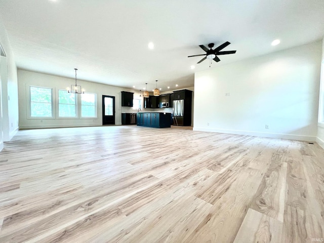 unfurnished living room featuring light wood-type flooring, recessed lighting, and baseboards