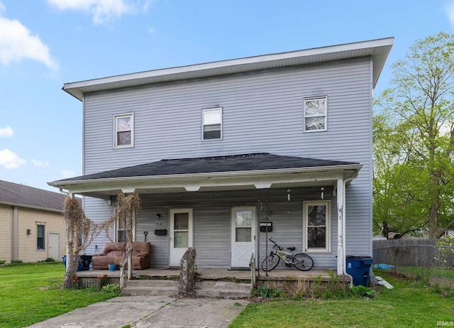 view of front of home featuring a porch, fence, and a front yard