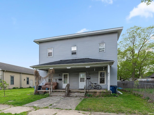 view of front of home featuring fence, a porch, and a front yard
