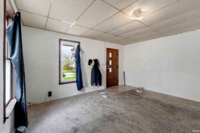 spare room with carpet flooring and a paneled ceiling