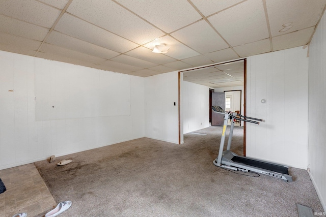 below grade area featuring carpet flooring and a drop ceiling
