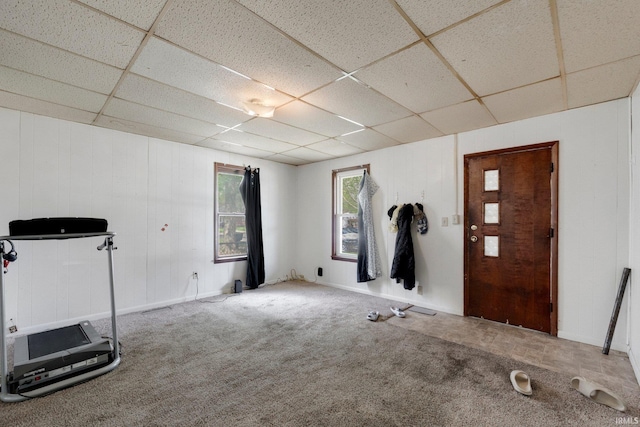 interior space featuring baseboards and a paneled ceiling