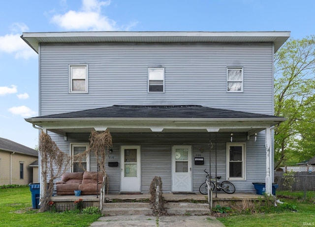 view of front of home featuring covered porch and fence